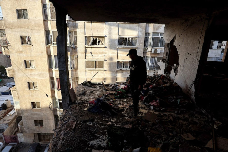 A Palestinian inspects the site of an Israeli strike on Saturday, in Gaza City, January 31, 2026.