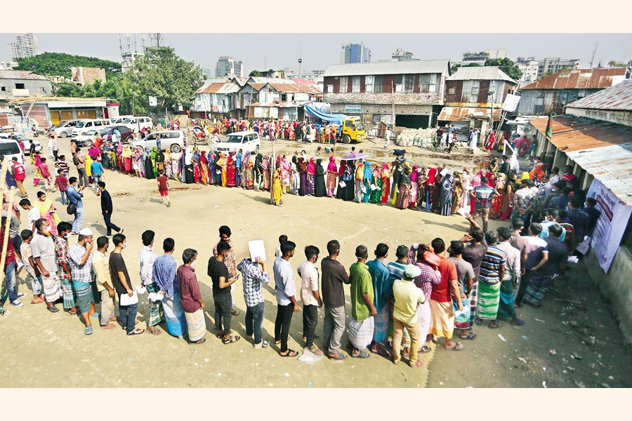 Residents of Korail slum, one of the largest informal settlements in Dhaka, stand in queues to get Covid jabs at Polli BondhuShishu Kalyan Primary School in Dhaka city.