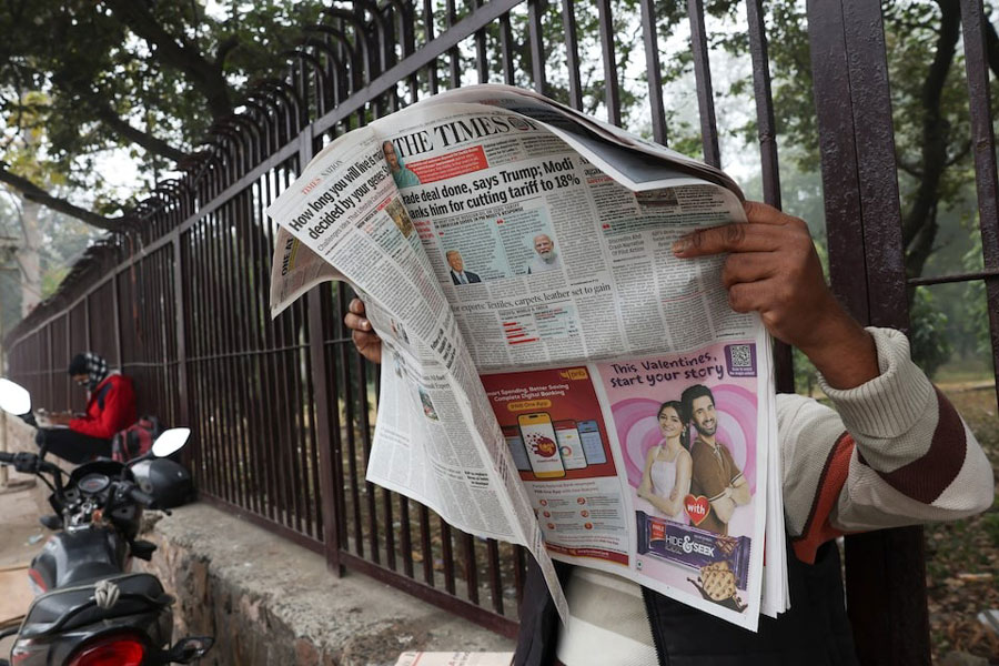 A man reads the latest edition of The Times of India newspaper, with the story on US tariffs on Indian imports slashed to 18 per cent, in New Delhi, India, February 3, 2026.