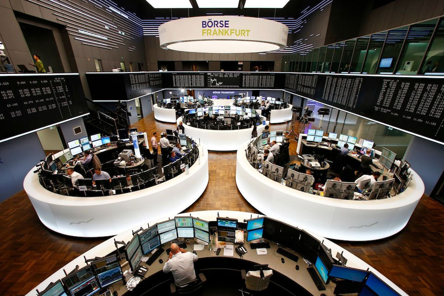Traders work at the stock exchange in Frankfurt.