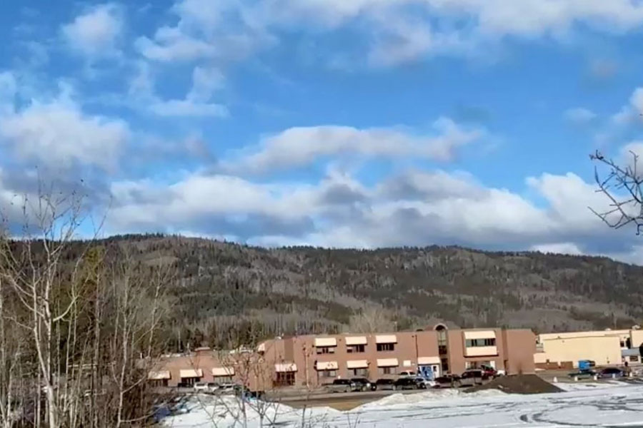Vehicles are parked outside the Tumbler Ridge Secondary School, the site of a deadly mass shooting in Tumbler Ridge, British Columbia, Canada, February 10, 2026, in this screengrab obtained from a social media video.