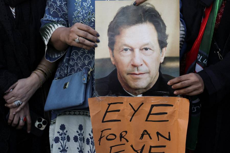 Supporters of jailed former Prime Minister Imran Khan’s Pakistan Tehreek-e-Insaf (PTI) party carry a poster of him during a protest over concerns about their leader’s health in Karachi, Pakistan, Feb 13, 2026.