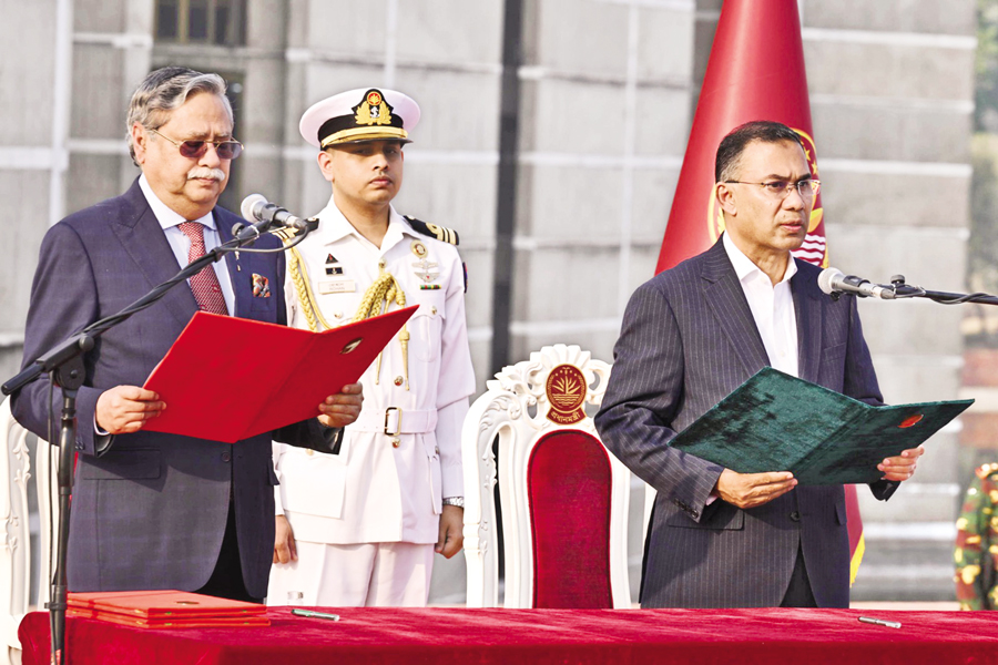 President Mohammed Shahabuddin administers the oath to Tarique Rahman as the country's 11th prime minister at the south plaza of the Jatiya Sangsad Bhaban in the capital on Tuesday. — Collected