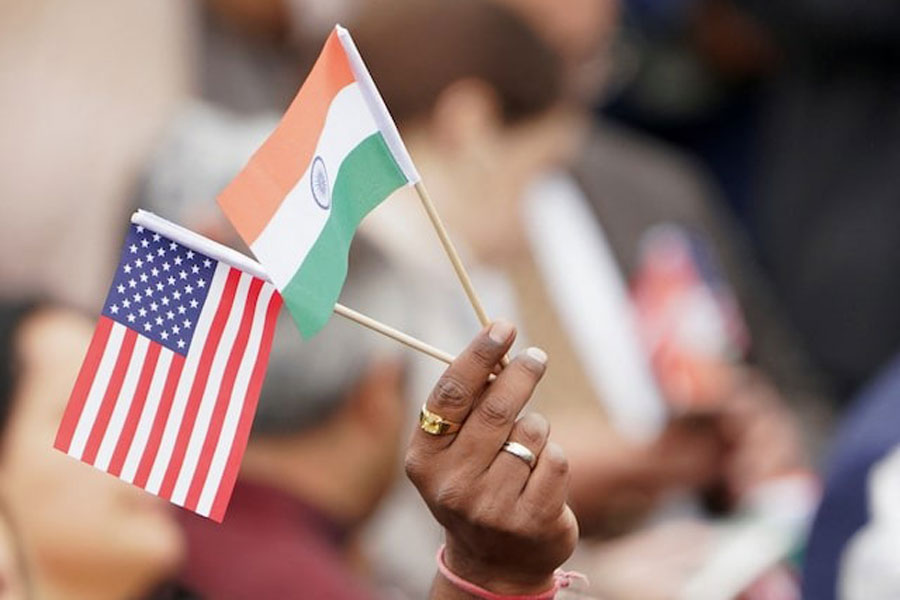 An attendee holds US and India's flags as they gather on the South Lawn of the White House in Washington, US, June 22, 2023.