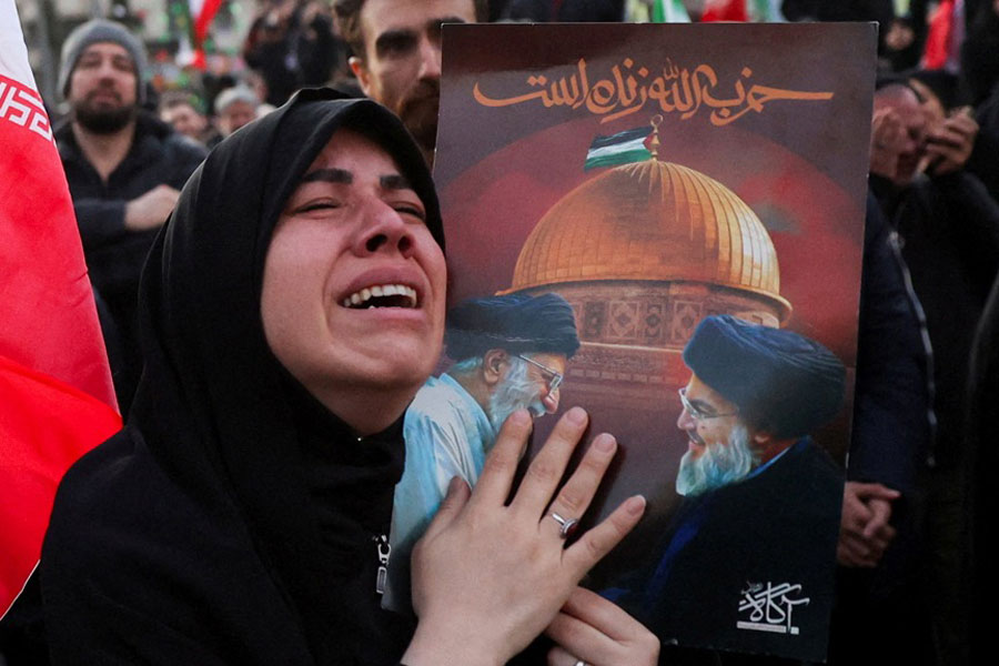 A woman reacts as people gather at the Enghelab Square, after Iran's Supreme Leader Ayatollah Ali Khamenei was killed in Israeli and US strikes on Saturday, in Tehran, Iran, March 1, 2026.