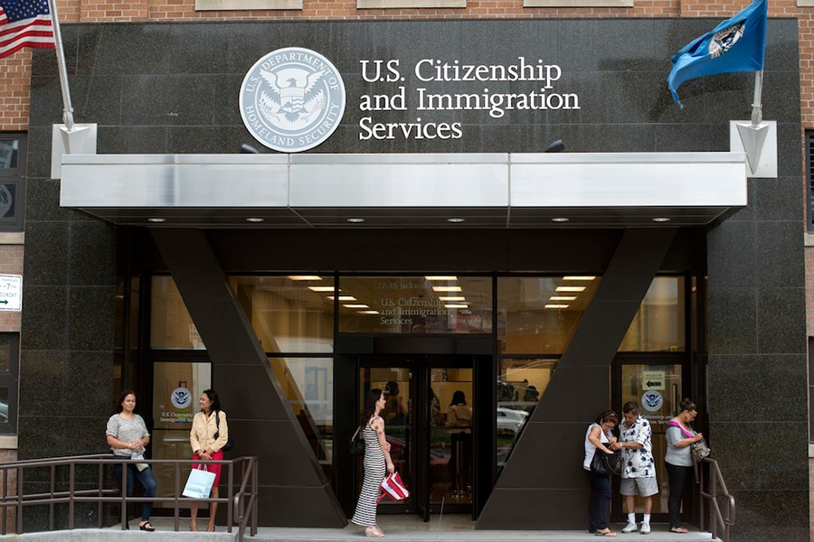 People stand on the steps of the US Citizenship and Immigration Services offices in New York on August 15, 2012 — REUTERS/File