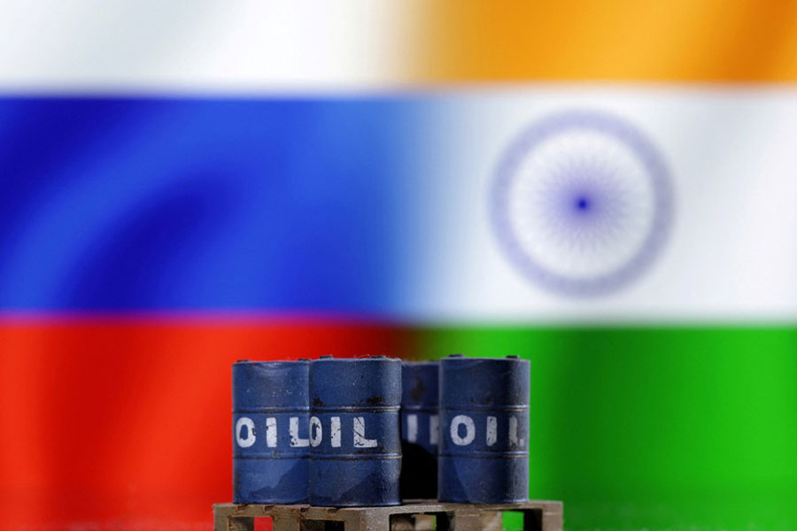 A model of oil barrels is seen in front of Russian and Indian flags in this illustration taken, Dec 9, 2022.