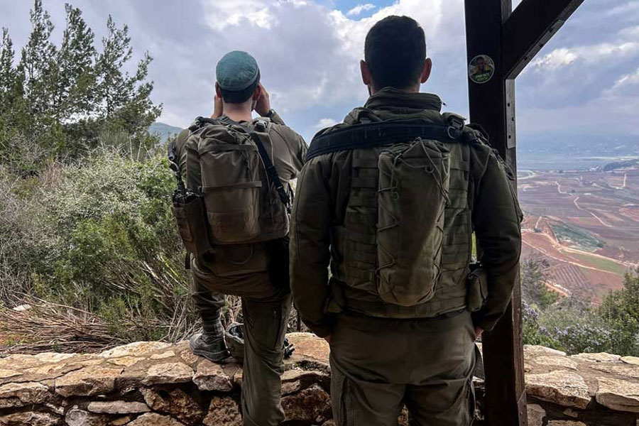 Israeli soldiers look towards Lebanon, amid an escalation between Iran-backed Hezbollah and Israel, and amid the US-Israeli conflict with Iran, by the Israel-Lebanon border in northern Israel Mar 7, 2026.