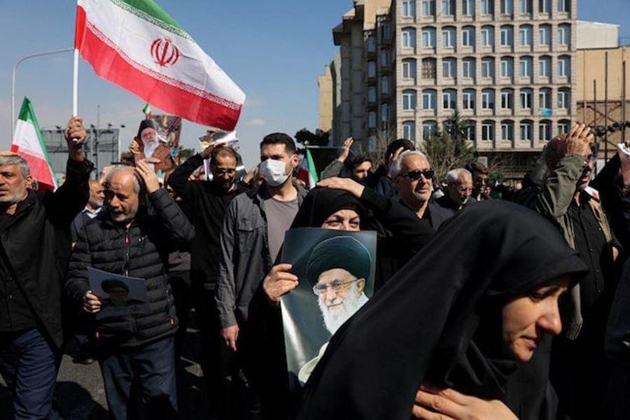 A demonstrator holds an image of Iran's late Supreme Leader Ayatollah Ali Khamenei, after he was killed in Israeli and US strikes on Saturday, during an anti-Israeli and US rally after Friday prayer, amid the US-Israeli conflict with Iran, in Tehran, Iran, March 6, 2026 — WANA (West Asia News Agency) via REUTERS