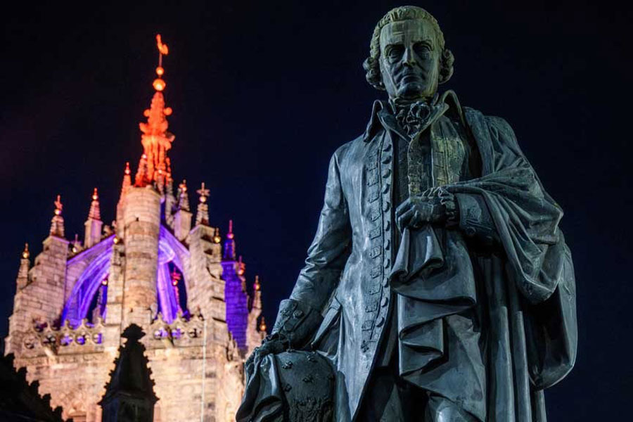 The bronze statue of Adam Smith, the renowned economist and philosopher, located on the Royal Mile, positioned just outside St Giles' Cathedral in Edinburgh, Scotland, Britain Feb 18, 2026.