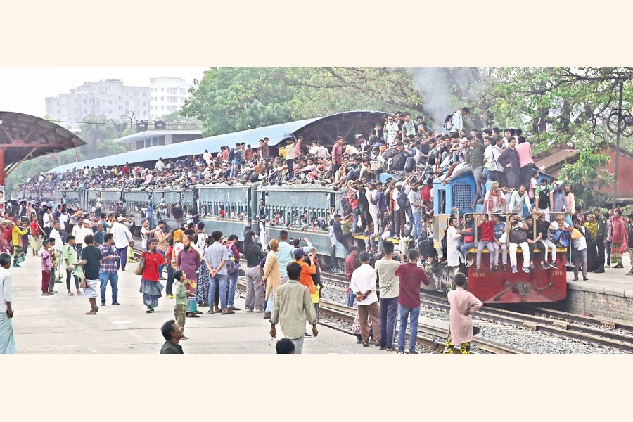 Trains see overwhelming crowds as Dhaka residents continue to leave for their hometowns on Wednesday to celebrate Eid-ul-Fitr. The photo was taken at Tongi Railway Station in Gazipur. — FE photo by K Asad-Uz-Zaman