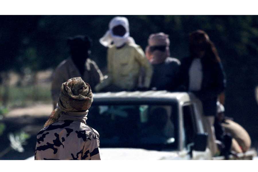 A Chadian soldier inspects a vehicle travelling between Chad and Sudan, amid the ongoing conflict between the paramilitary Rapid Support Forces (RSF) and the Sudanese Army, at the Tine border post in eastern Chad, Nov 22, 2025.