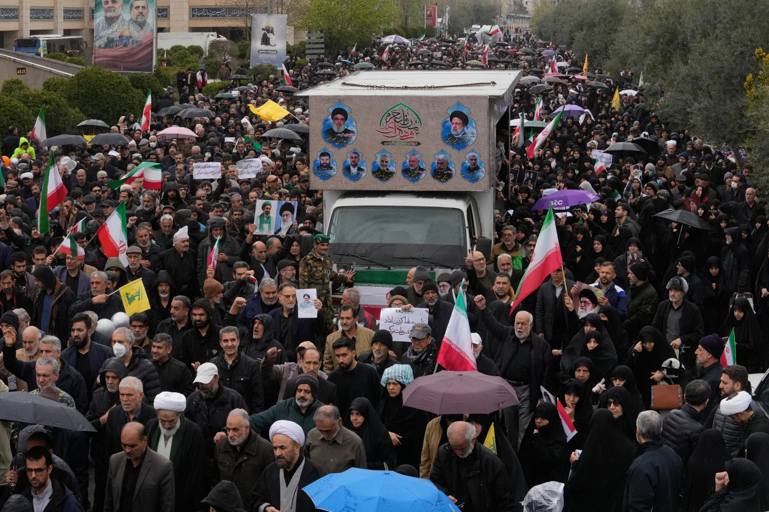 Iranians follow a truck carrying the coffins of Iran`s intelligence minister Esmail Khatib and, according to Iranian officials, his wife and daughter, during a funeral procession in Tehran, Iran, Friday, March 20, 2026. (AP Photo/Vahid Salemi)