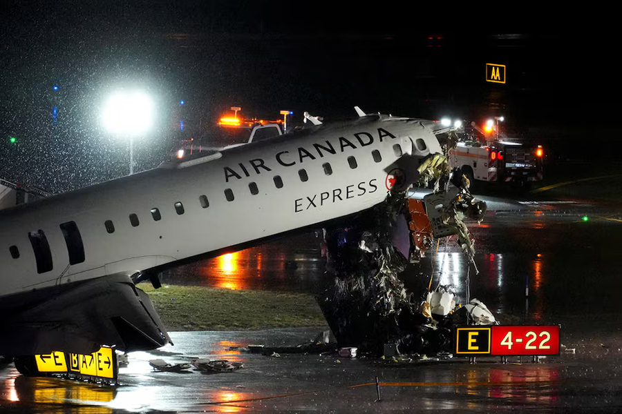 Debris hangs from a damaged Air Canada Express jet that had collided with a fire truck at New York's LaGuardia Airport in Queens, New York, US, on March 23, 2026 — Reuters photo