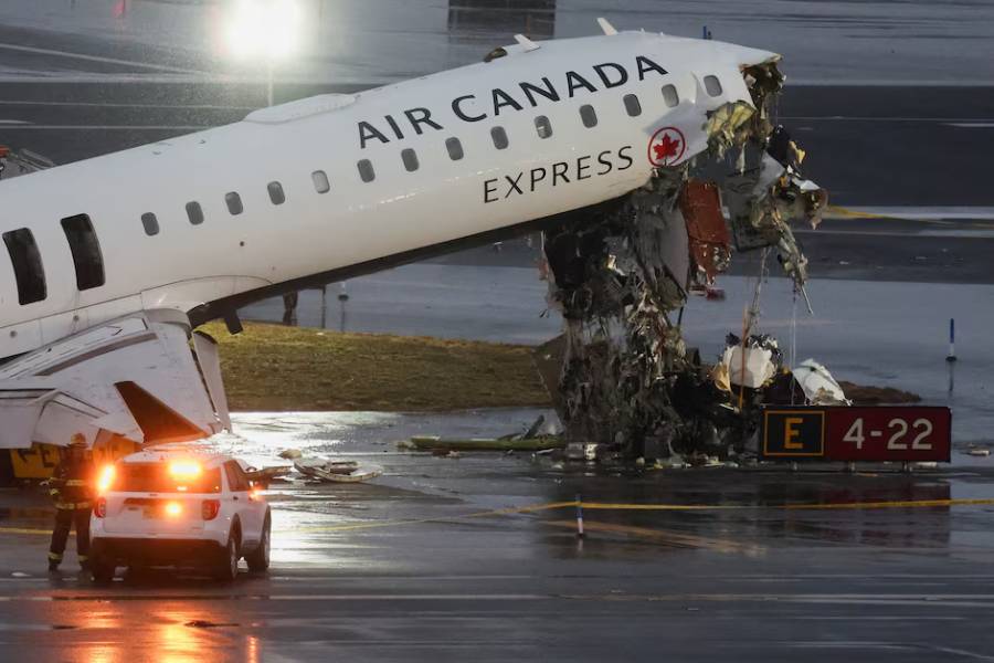 Debris hangs from a damaged Air Canada Express jet that had collided with a ground vehicle at New York's LaGuardia Airport in Queens, New York, U.S., March 23, 2026.
