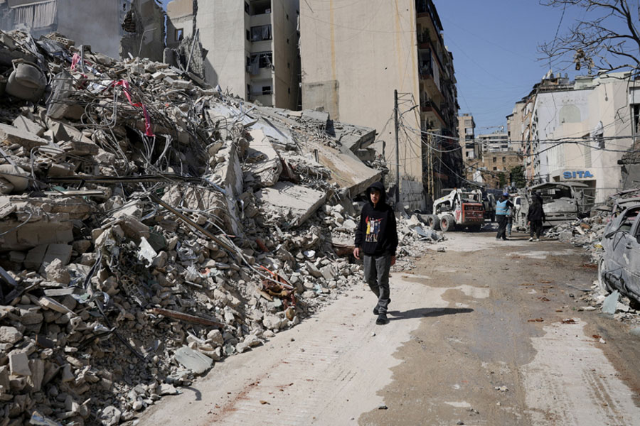 A person walks past debris at the site of an Israeli strike, following an escalation between Hezbollah and Israel amid the US-Israeli conflict with Iran, Zuqaq al-Blat district in central Beirut, Lebanon, Mar 18, 2026.