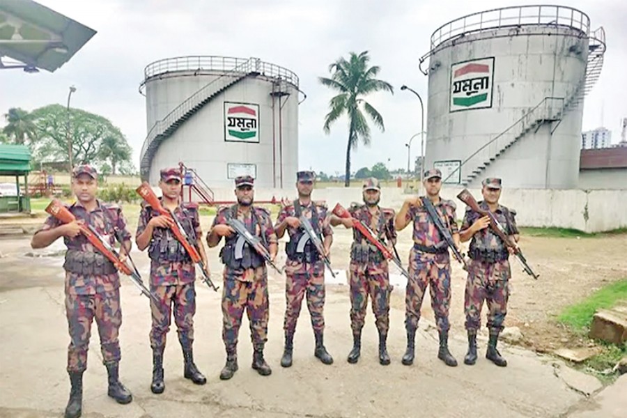 Members of Border Guard Bangladesh (BGB) stand guard in front of fuel storage tanks at a depot of Jamuna Oil Company Limited in Sylhet on Saturday to prevent hoarding and ensure uninterrupted fuel supply. — Focus Bangla