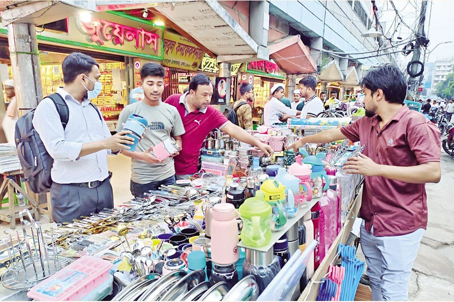 Businesses in the capital revive after the end of the Eid-ul-Fitr holidays. The photo was taken from the Baitul Mukarram area on Sunday, the first working day after the vacation. — FE Photo by K Asad-Uz-Zaman