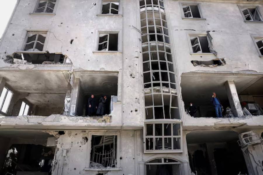 People inspect damage to a residential building after it was hit by a strike, amid the U.S.-Israeli conflict with Iran, in Tehran, Iran, March 30, 2026.