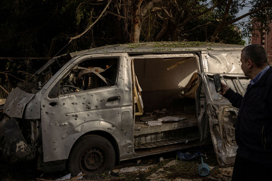 A man takes a photo of a damaged car following an Israeli strike, amid escalating hostilities between Israel and Hezbollah, as the US-Israel conflict with Iran continues, in Beirut, Lebanon, Apr 1, 2026.