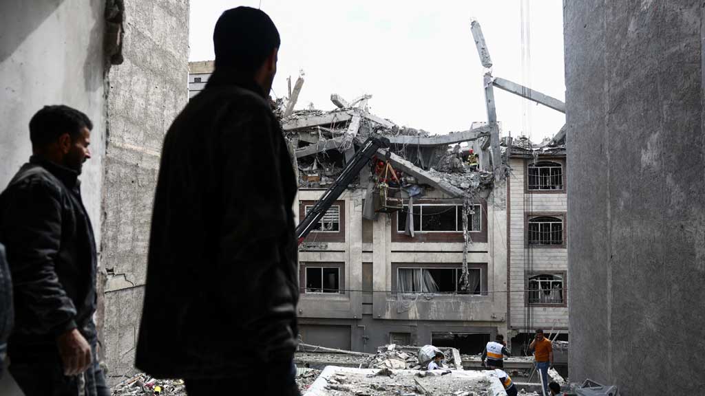 A man looks at a residential building damaged by a strike, amid the US-Israeli conflict with Iran, in Tehran, Iran, Mar 27, 2026. Majid Asgaripour/WANA (West Asia News Agency) via REUTERS