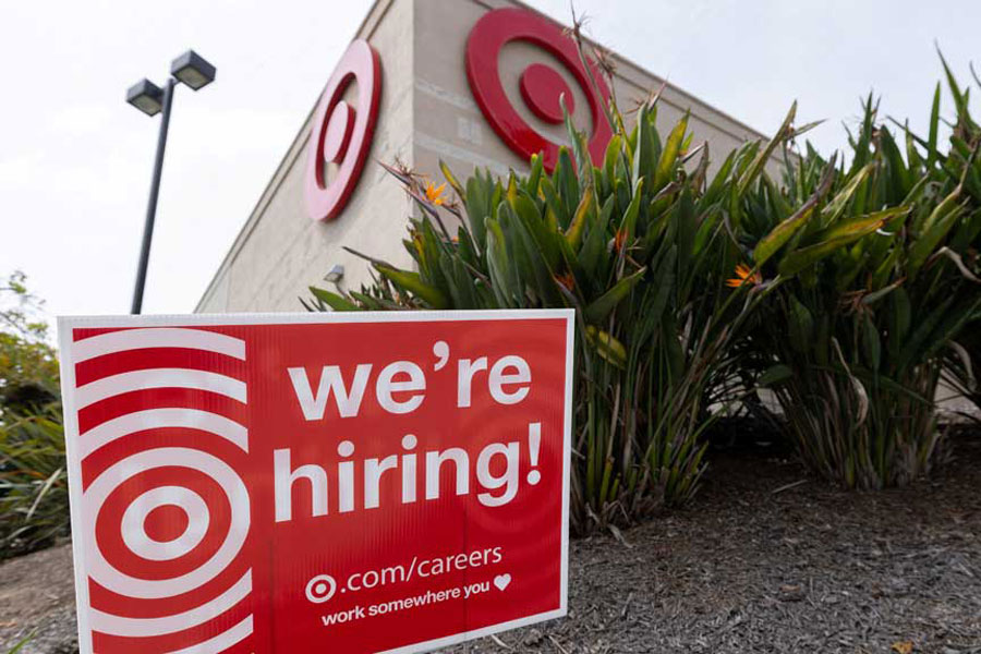 A sign posted outside a Target store states the company is hiring in Encinitas, California, US, Mar 30, 2026.