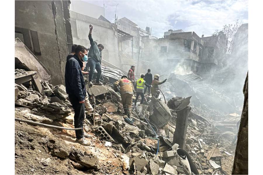 People gather as rescuers work at the site of an Israeli strike, amid escalating hostilities between Israel and Hezbollah, as the U.S.-Israel conflict with Iran continues, in the Jnah area in Beirut, Lebanon, April 5, 2026.