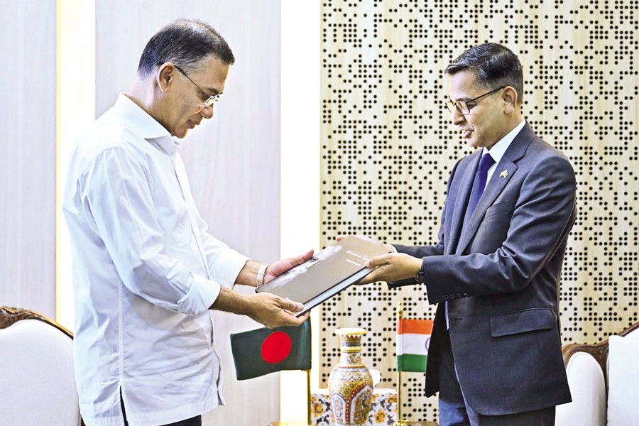 Indian High Commissioner Pranay Verma presenting a book to Prime Minister Tarique Rahman after their meeting at the Secretariat in the capital on Monday. — PID