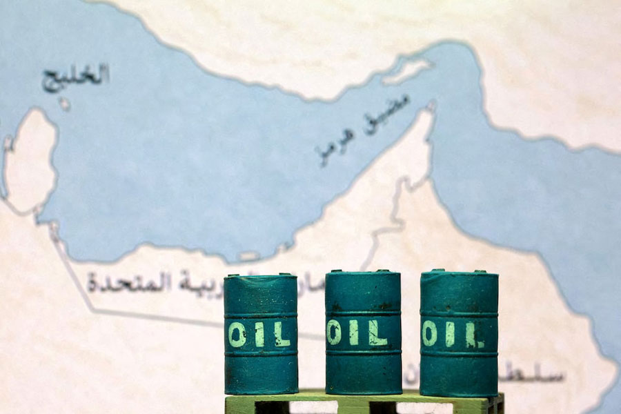 A map showing the Strait of Hormuz, also known as Madiq Hurmuz, and 3D printed oil barrels are seen in this illustration taken March 26, 2026.