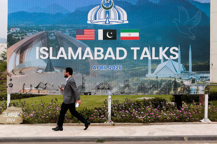 A man walks past a billboard near the media centre as delegations from the United States and Iran are expected to hold peace talks in Islamabad, Pakistan, on April 11, 2026 — Reuters photo
