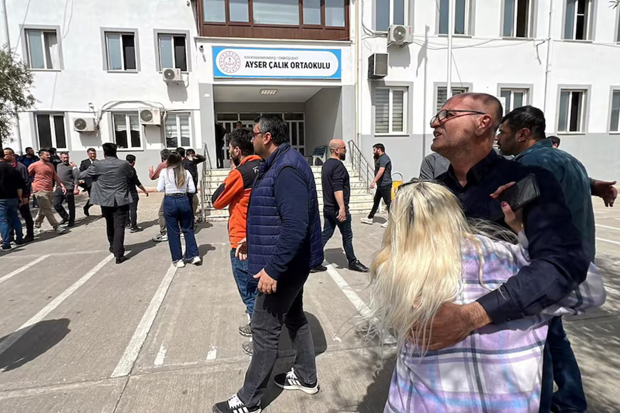 People wait in front of the school building after a deadly shooting, in the southeastern province of Kahramanmaras, Turkey, on April 15, 2026 — IHA (Ihlas News Agency) via REUTERS