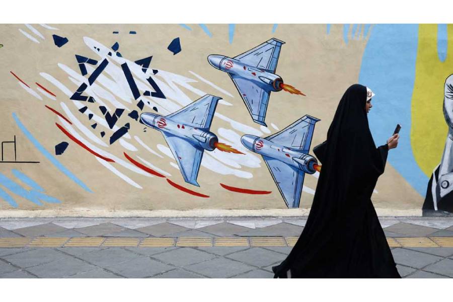 A woman walks next to an anti-Israeli mural on a street, amid a ceasefire between US and Iran, in Tehran, Iran, Apr 20, 2026.