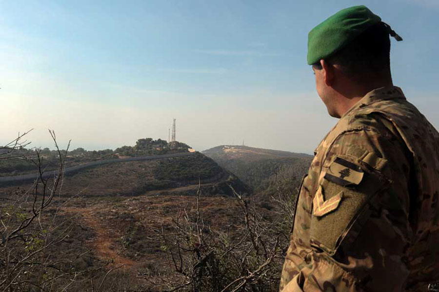 A Lebanese soldier looks towards the Lebanese-Israeli border, in Naqoura, Lebanon, Nov 28, 2025.