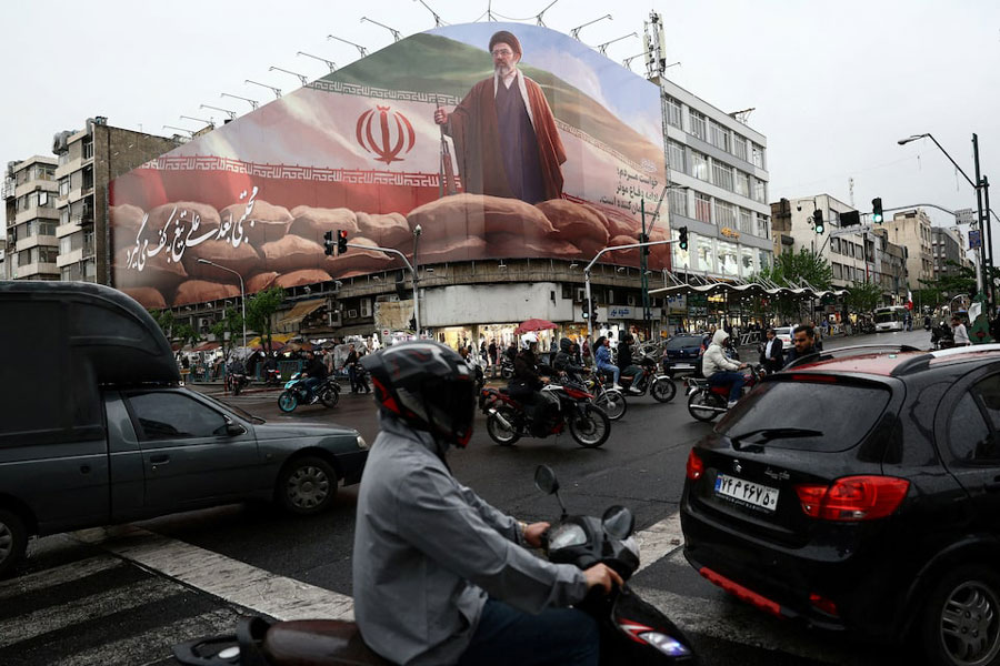 People ride motorcycles near a billboard featuring an image of Iran's new Supreme Leader Mojtaba Khamenei, amid a ceasefire between U.S. and Iran, in Tehran, Iran, April 20, 2026.