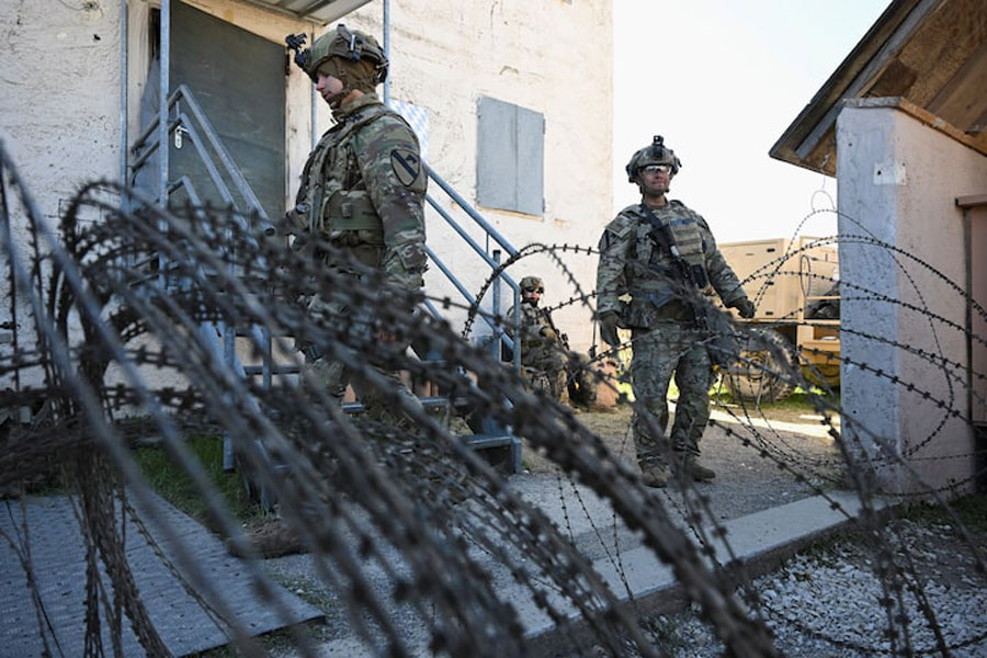 Soldiers stand next to a razor wire at a media day during the US Army Combined Resolve exercise at the US Army's southern Germany training facilities in Hohenfels, Germany, April 30, 2026.