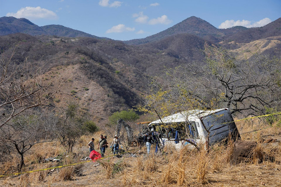 People and staff from the Nayarit Attorney General's office stand near the site where a tourist bus overturned, killing several people and injuring others near the town of Amatlan de Canas, in the western state of Nayarit, Mexico on May 1, 2026 — Reuters photo