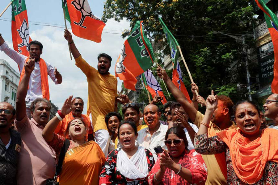 India's ruling Bharatiya Janata Party (BJP) supporters celebrate as early trends show their party leading in the West Bengal state assembly election results, outside the party's regional office in Kolkata, India, May 4, 2026.
