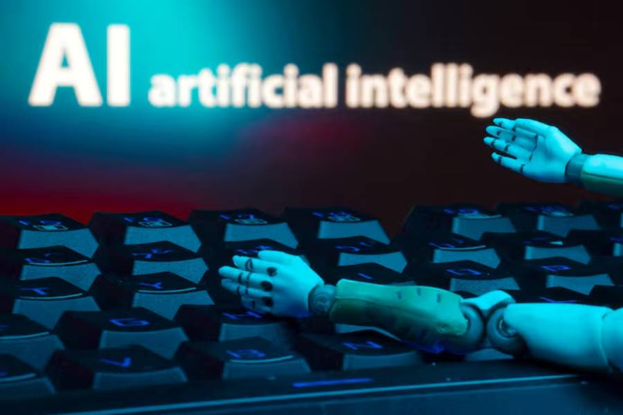 A message reading "AI artificial intelligence", a keyboard, and robot hands are seen in this illustration taken January 27, 2025.
