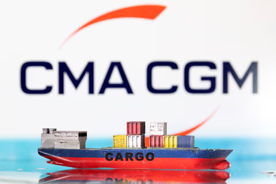 A cargo ship boat model is pictured in front of the CMA CGM logo in this illustration taken March 3, 2022.