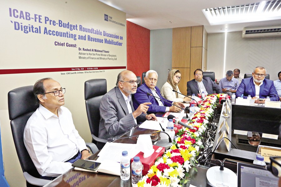 Dr Rashed Al Mahmud Titumir, finance and planning adviser to the prime minister, addresses a pre-budget roundtable as the chief guest at CA Bhaban in the capital's Karwan Bazar on Thursday. The event, jointly organised by The Financial Express and the Institute of Chartered Accountants of Bangladesh, was chaired by Financial Express Editor Shamsul Huq Zahid. — FE photo