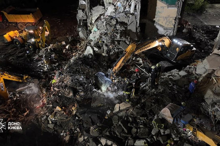 Firefighters work at a site of the apartment building damaged during yesterday's Russian missile and drone strike, amid Russia's attack on Ukraine, in Kyiv, Ukraine in this handout picture released May 15, 2026.