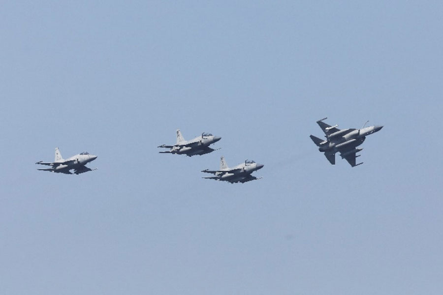 Pakistan Air Force's JF-17 Thunder jets fly past during the sea phase of Pakistan Navy's Multinational Exercise AMAN-23, in the North Arabian Sea near Karachi, Pakistan, February 13, 2023.
