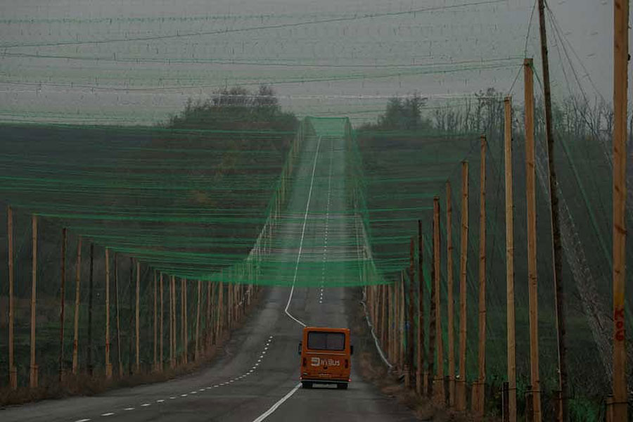 A car drives along a road covered with an anti-drone net, amid Russia's attack on Ukraine, near the town of Sloviansk in Donetsk region, Ukraine Oct 27, 2025.