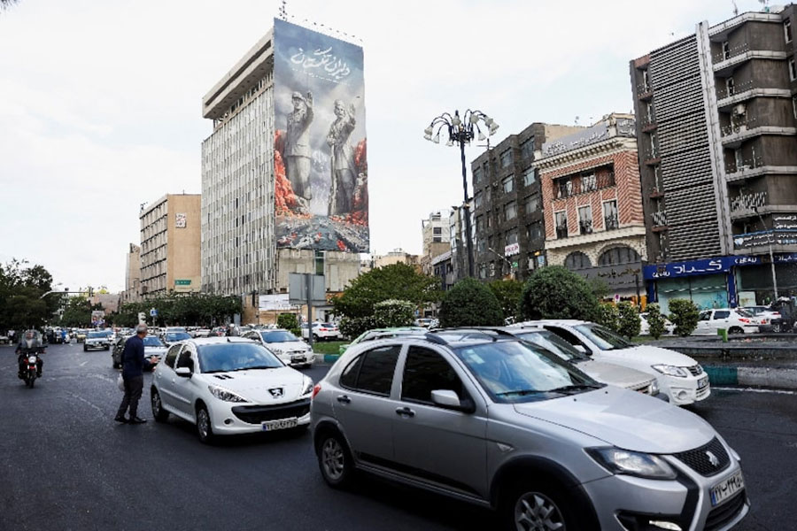People drive past a billboard about the Strait of Hormuz, in Tehran, Iran, May 17, 2026.