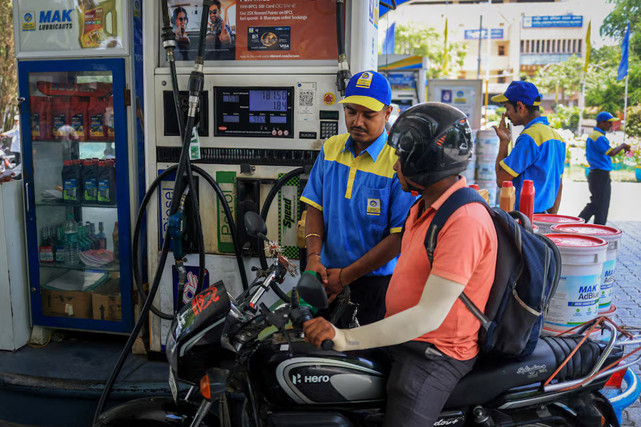 A worker fills a motorcycle's tank with petrol as newly increased fuel prices are displayed at a pump in New Delhi, India, on May 19, 2026 — Reuters photo