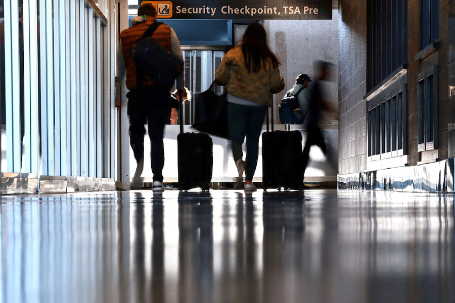 Travelers wait to pass a security checkpoint at Dulles International airport in Dulles, Virginia, US November 13, 2025.