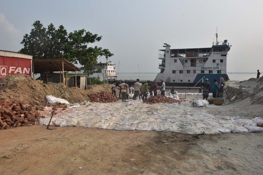 Construction work of a connecting road is underway at ghat No. 3 on the Paturia-Daulatdia ferry route before the Eid-ul-Azha rush begins. — FE Photo