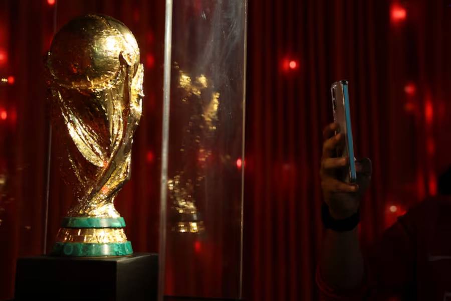 A man takes a photo of a replica of the World Cup trophy as he visits the "Epic Album" exhibition, the biggest football exhibition in Latin America that contains relics of legends such as Ronaldo, Cruyff, Pelé and a collection of Mexican national team t-shirts, as the 2026 FIFA World Cup approaches in Mexico at the Museo Yancuic, in Mexico City, Mexico May 15, 2026.