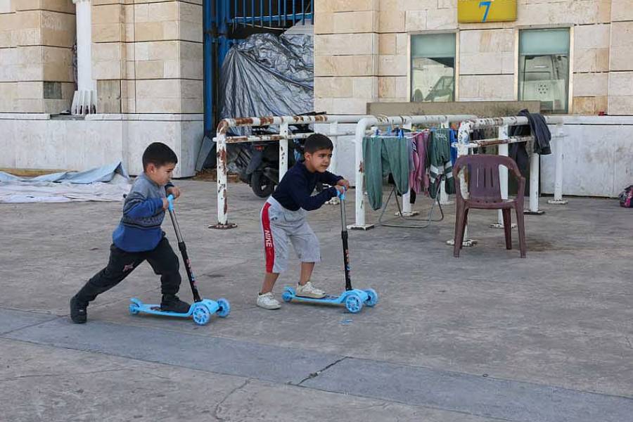 Children play outside Camille Chamoun Sports City stadium, turned into a temporary shelter in Beirut, Lebanon, May 8, 2026.