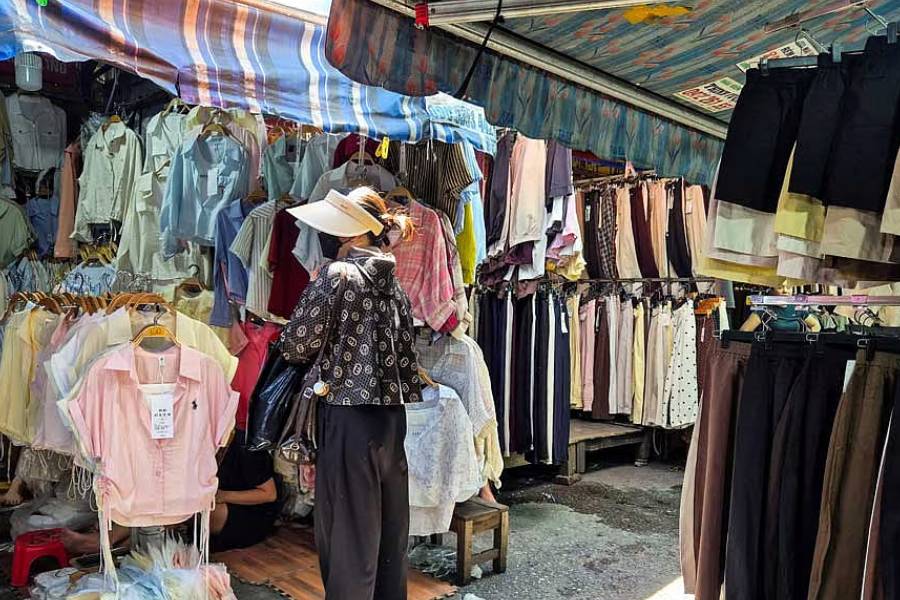 A woman shops at Ninh Hiep market, classified by the US Trade Representative among "notorious markets" for counterfeiting, despite government crackdowns and the threat of US tariffs over the issue, on the outskirts of Hanoi, Vietnam, May 25, 2026.